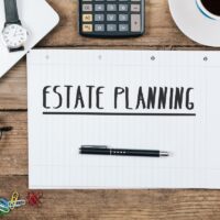 Estate Planning text, Office desk with computer technology, high