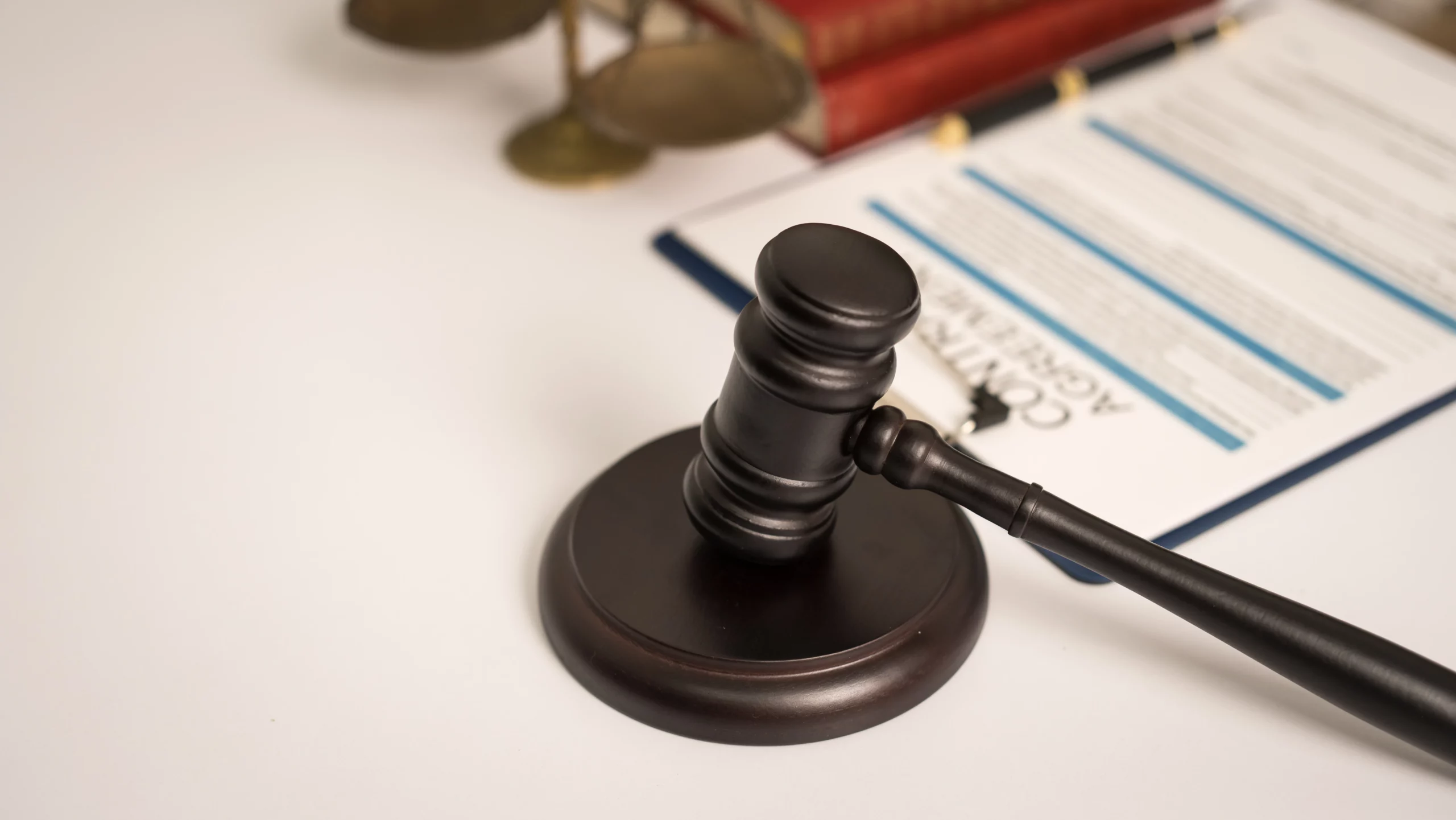 Judge’s gavel on desk with legal contract documents symbolizing breach of fiduciary duty by trustees.