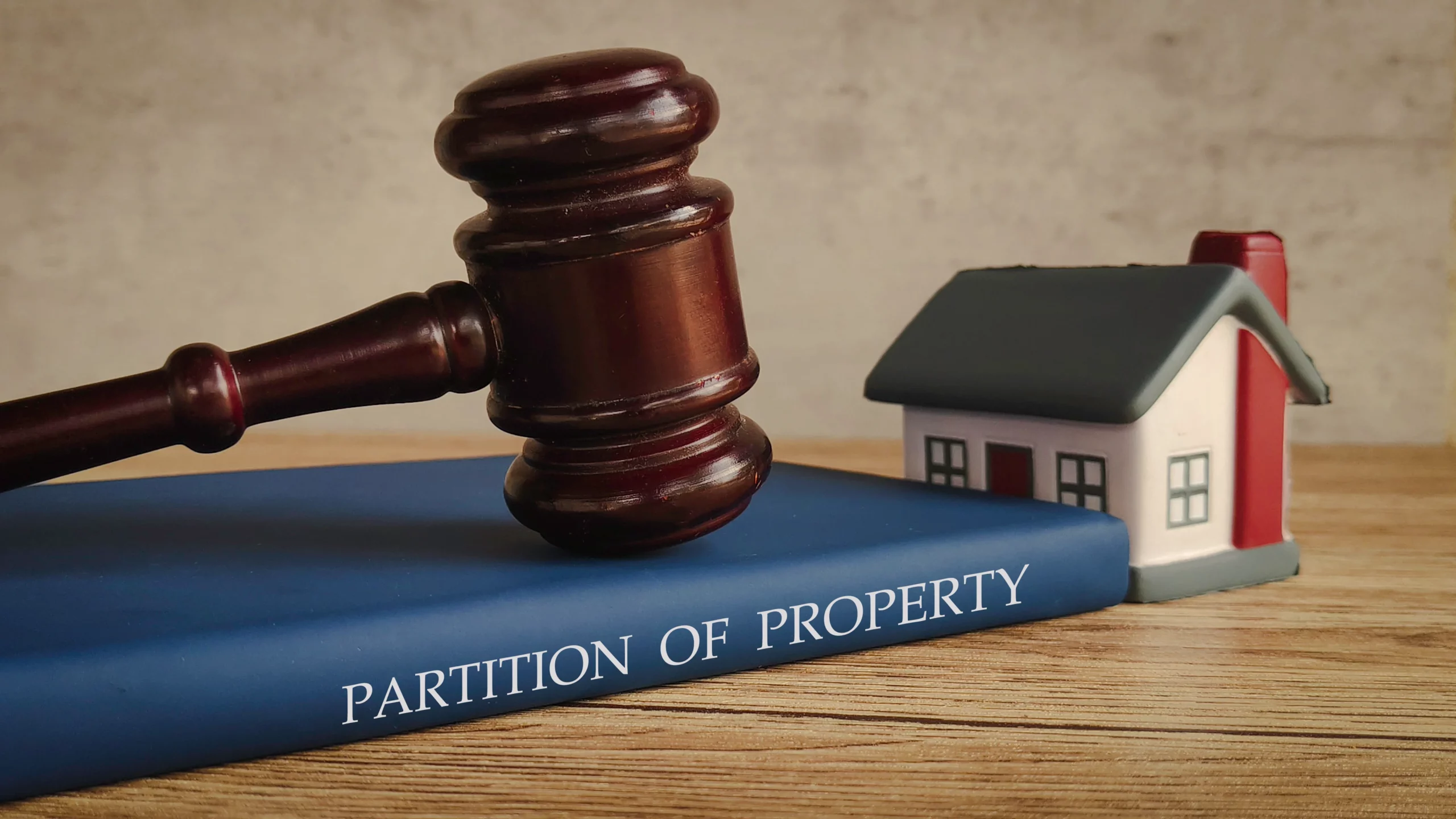 Judge's gavel and model house representing partition actions for inherited property in California